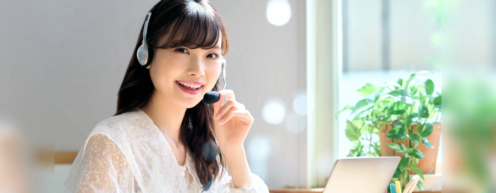 A woman smiling during an online lesson with a headset